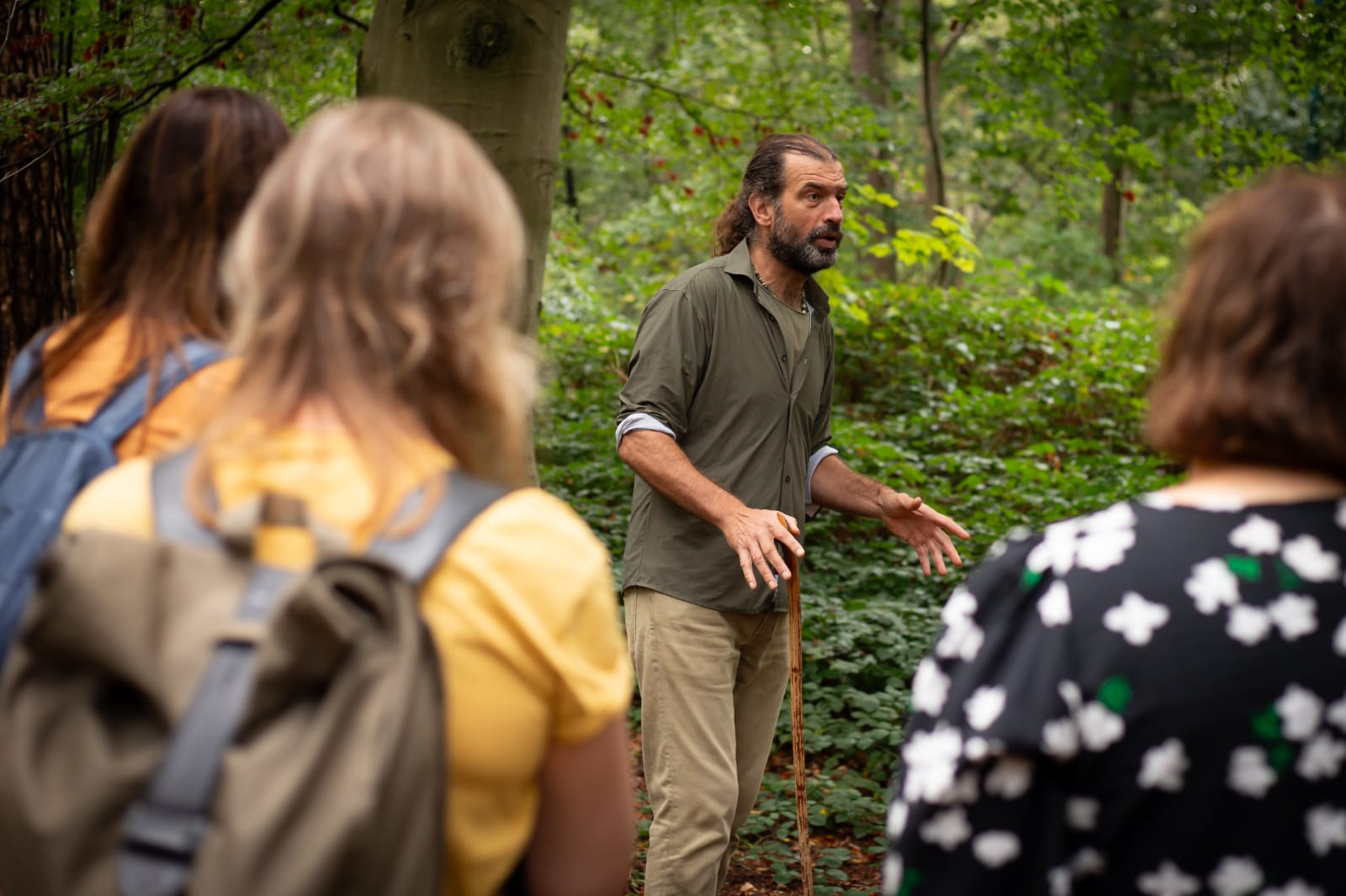 René van Dalen in gesprek met een groep deelnemers in het bos